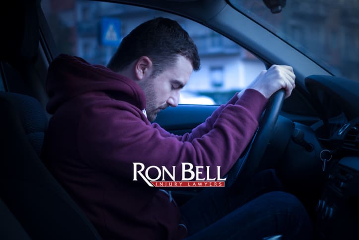 Man driving car and falling asleep