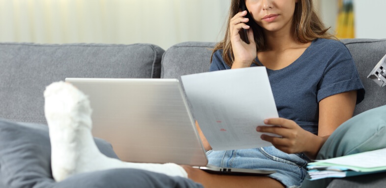 Social Security Disability woman on the phone reviewing documentation